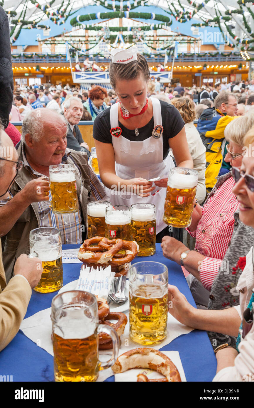 Germany, Bavaria, Munich, Oktoberfest, Waitress at Table inside Beer