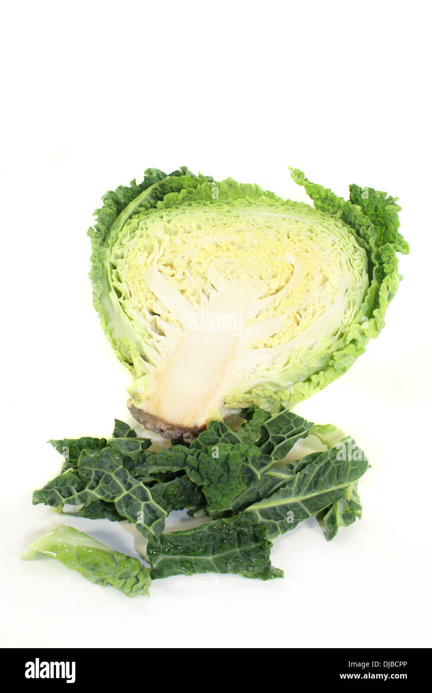 a sliced savoy cabbage against white background Stock Photo