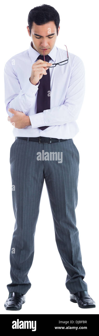 Unsmiling businessman holding glasses Stock Photo