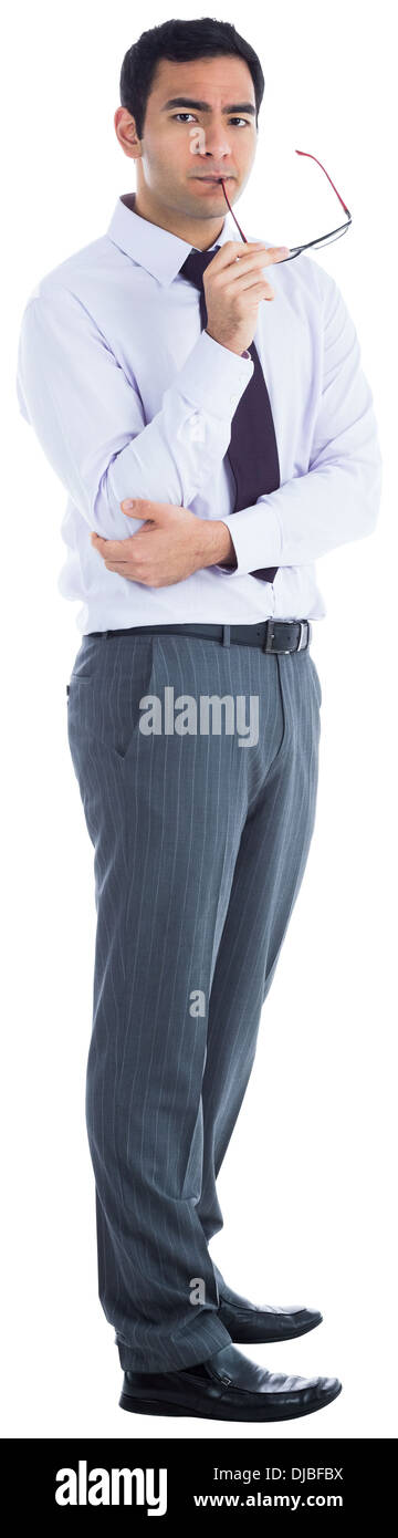 Unsmiling businessman holding glasses Stock Photo