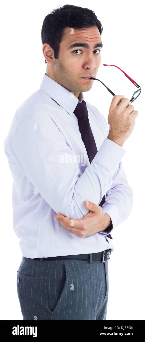 Unsmiling businessman holding glasses Stock Photo