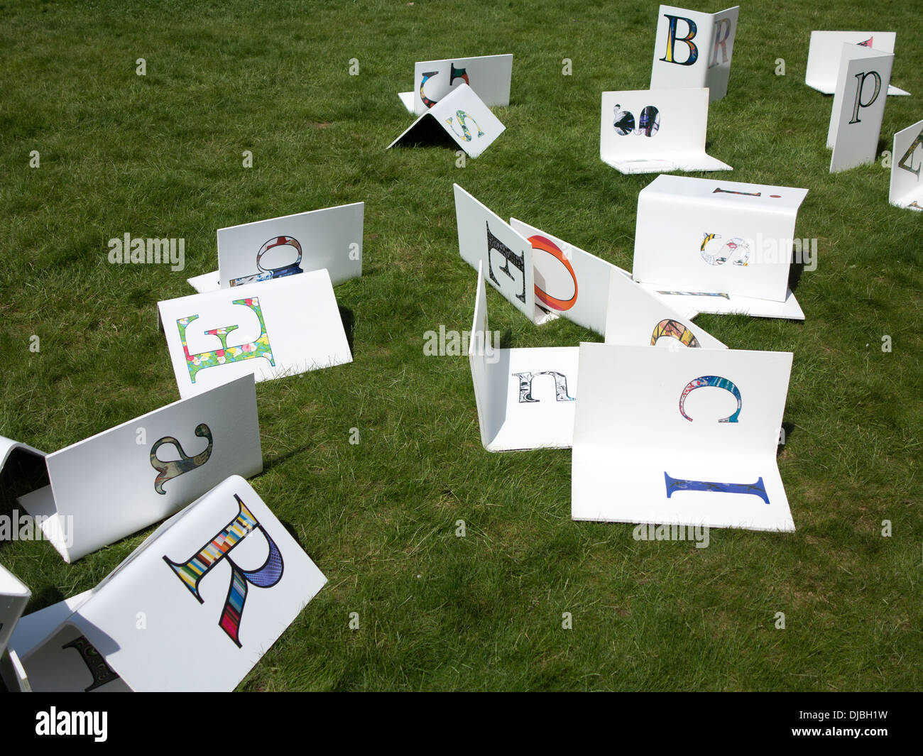 Random Letters randomly spread on grass jumbled up Stock Photo