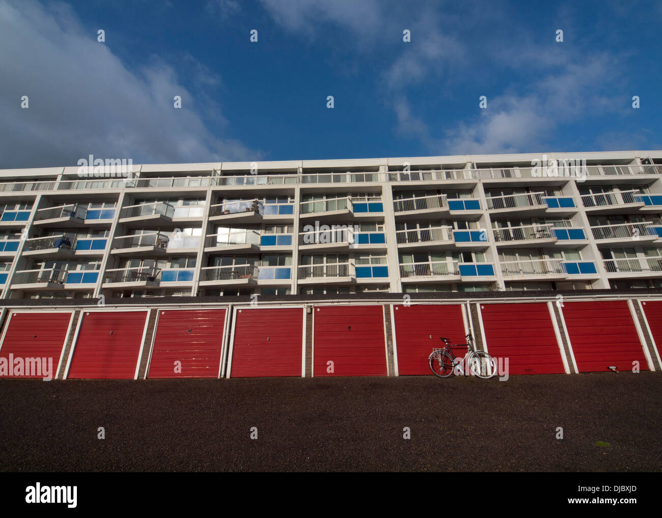 Red garage doors by a block of flats in Shoreham-by-Sea Stock Photo