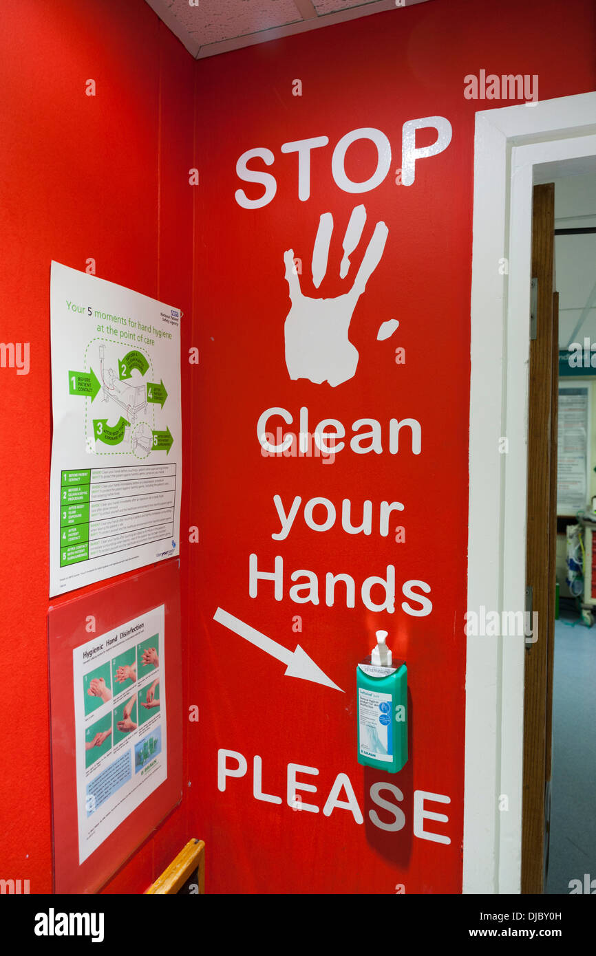 Hospital ward entrance signage for visitors to clean and disinfect hands. Stock Photo
