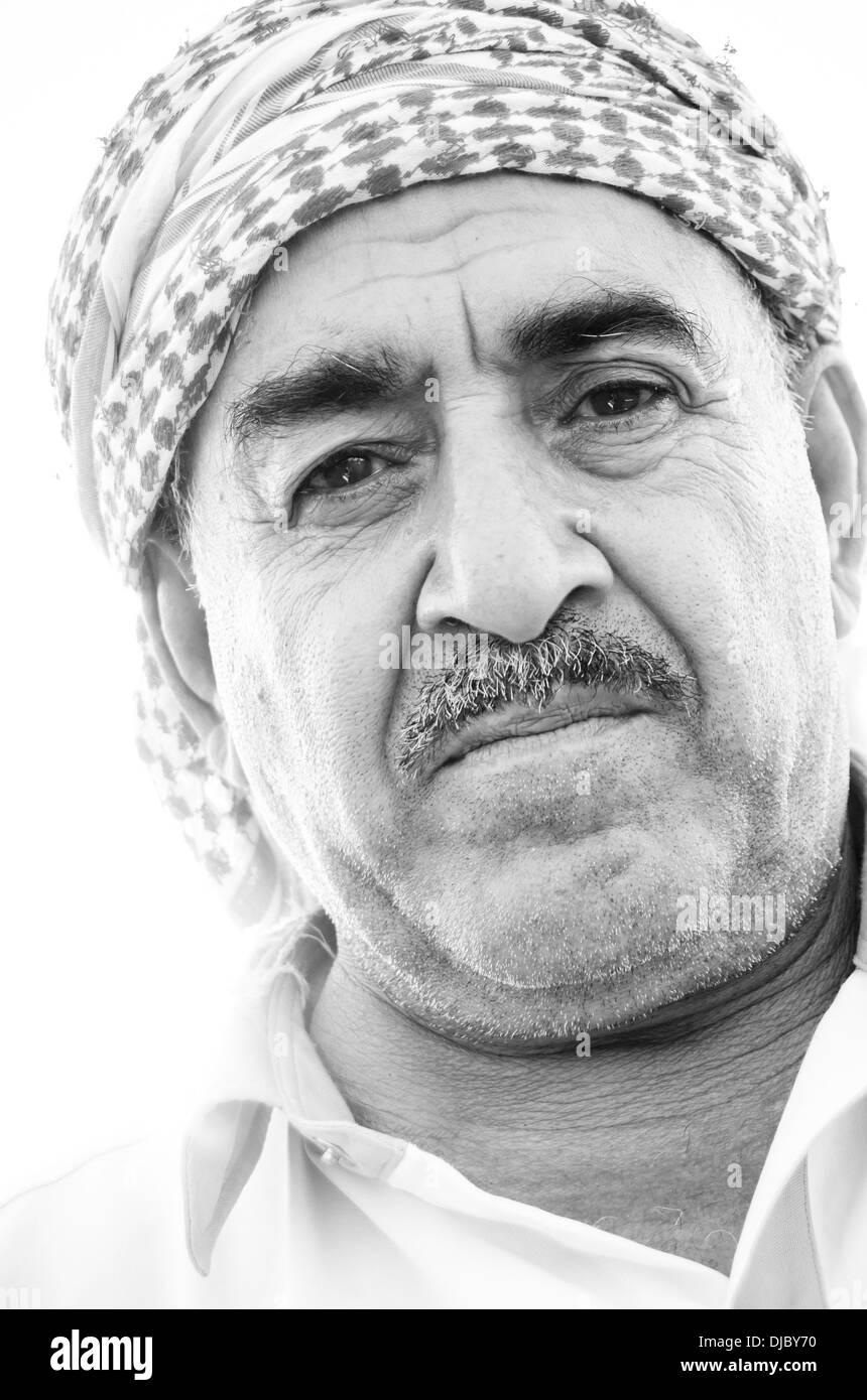 Portrait of Arab man wearing a shemagh with it's distinctive red and white checkered pattern. Dubai, UAE. Stock Photo