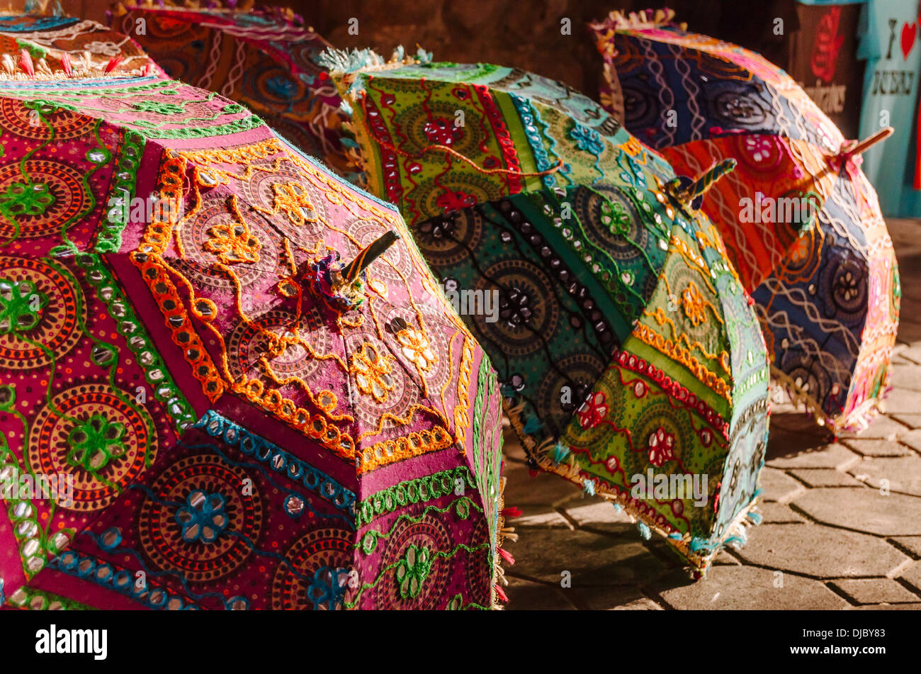 Colorful hand embroidered umbrellas from India are for sale at Bur