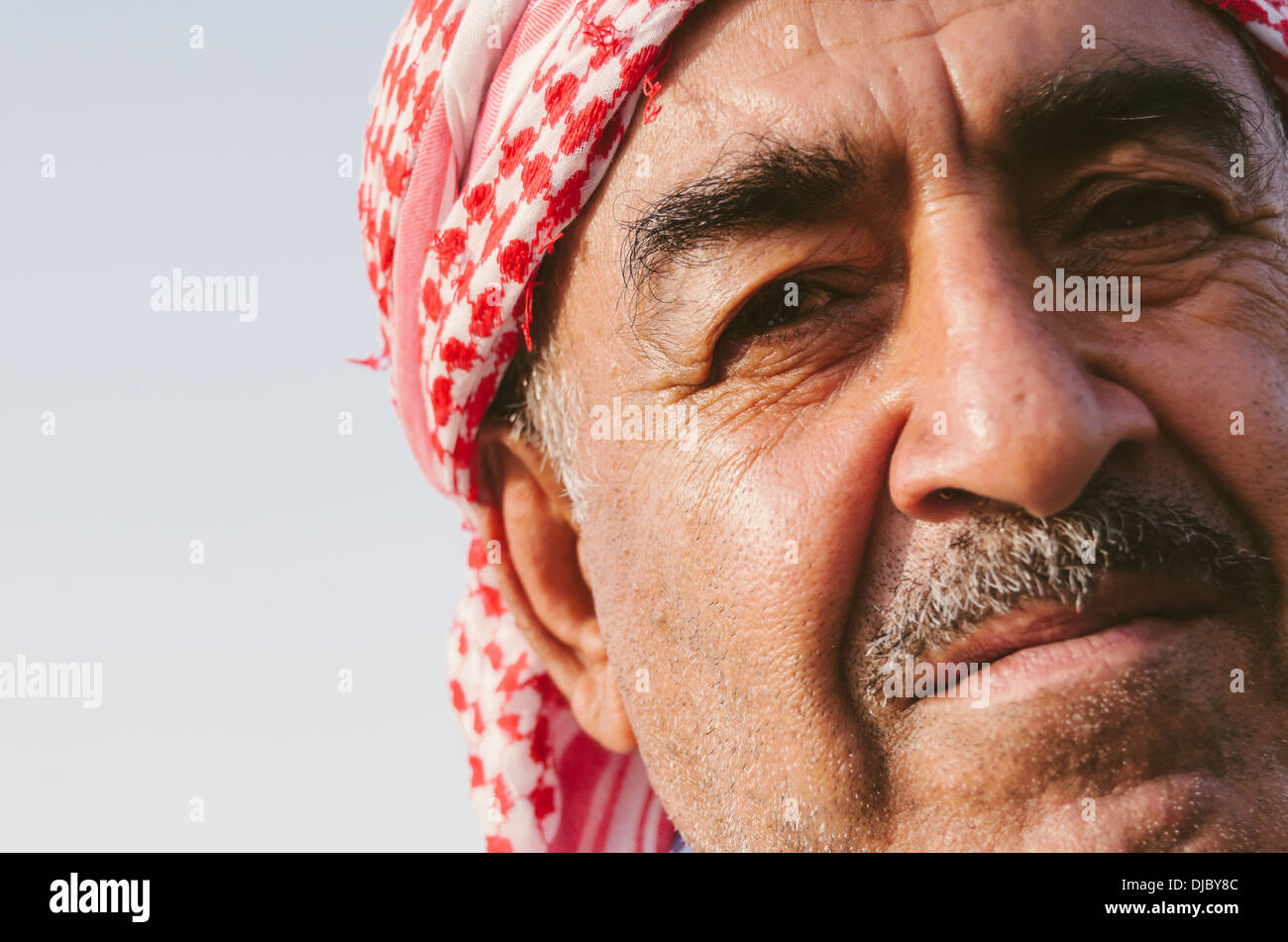Portrait of Arab man wearing a shemagh with it's distinctive red and white checkered pattern. Dubai, UAE. Stock Photo