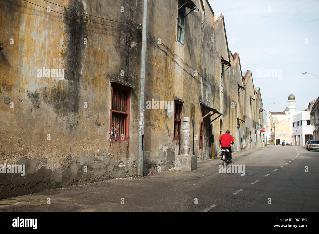 A man cycling in street of Georgetown, Penang, part on Unesco World Heritage Sit Stock Photo