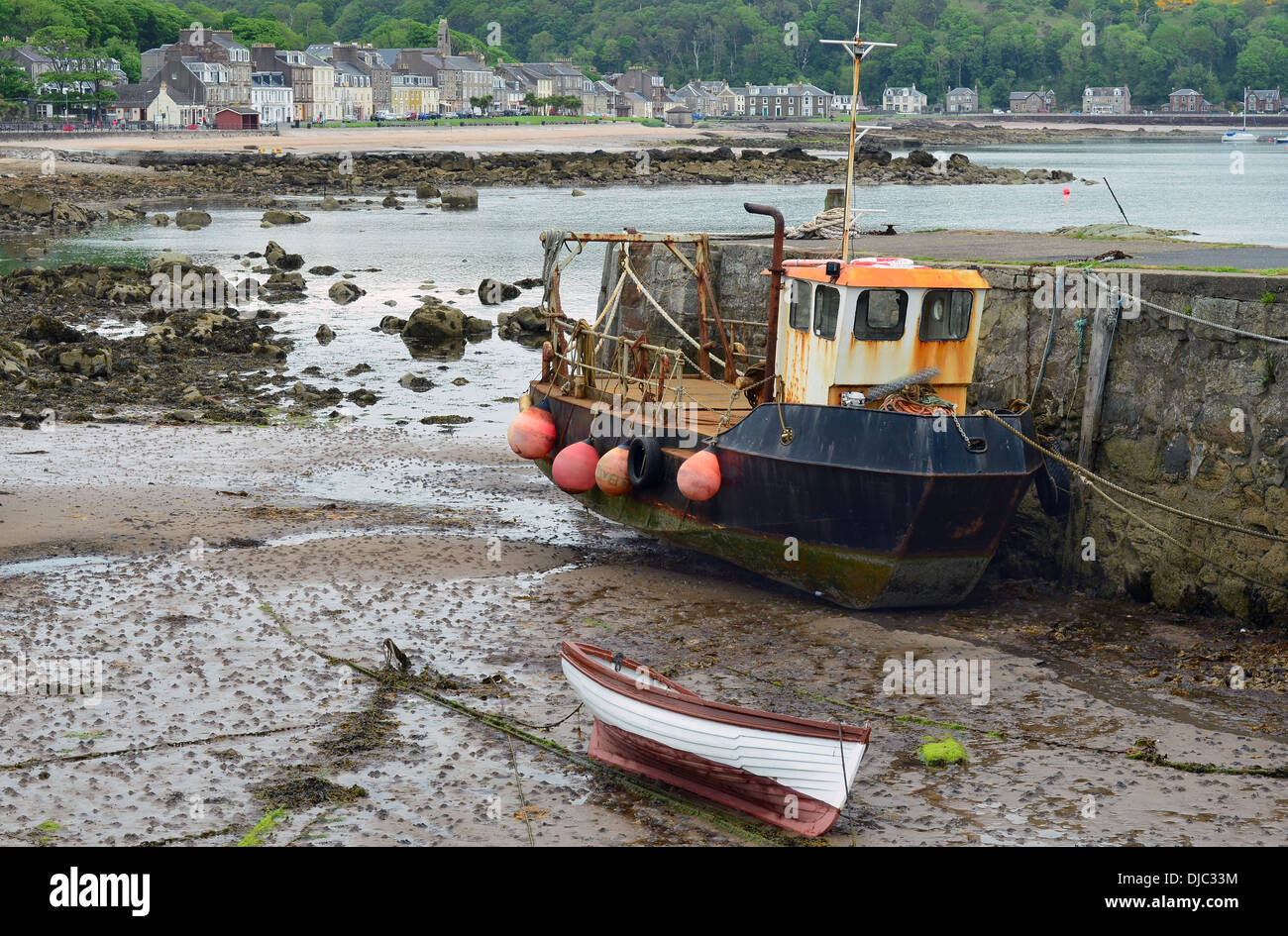 Small fishing boat in harbour whilst the tide is out. Millport, Scotland. Stock Photo