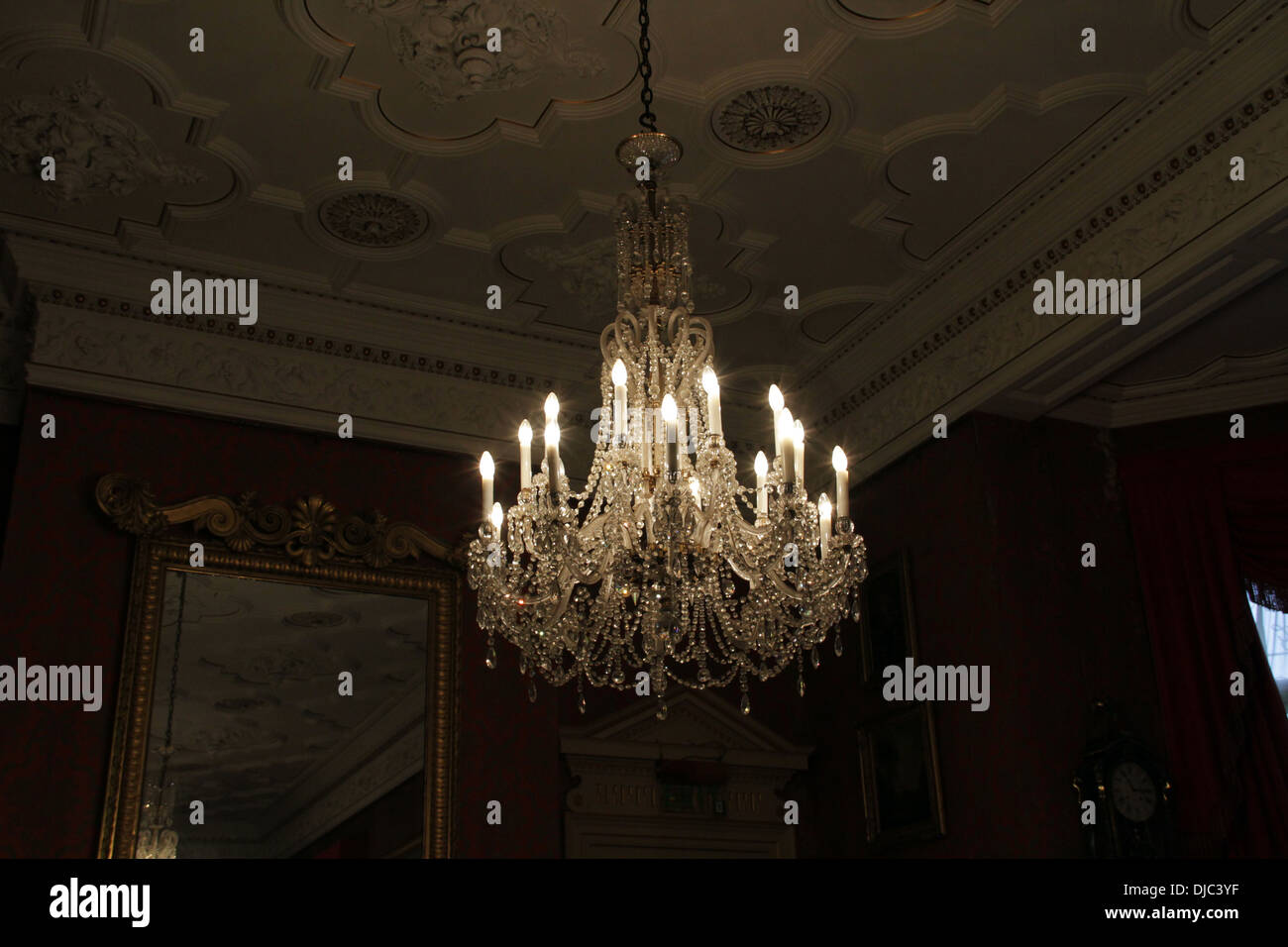 Lite chandelier hanging from a ceiling Stock Photo