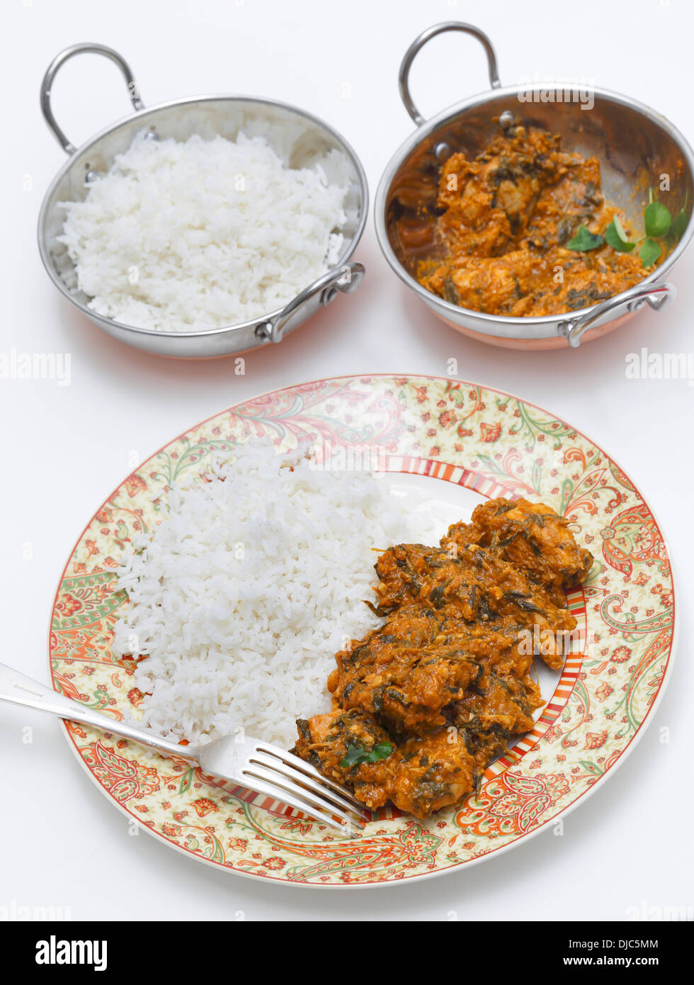Methi murgh - chicken cooked with fresh fenugreek leaves - served on a plate with rice Stock Photo