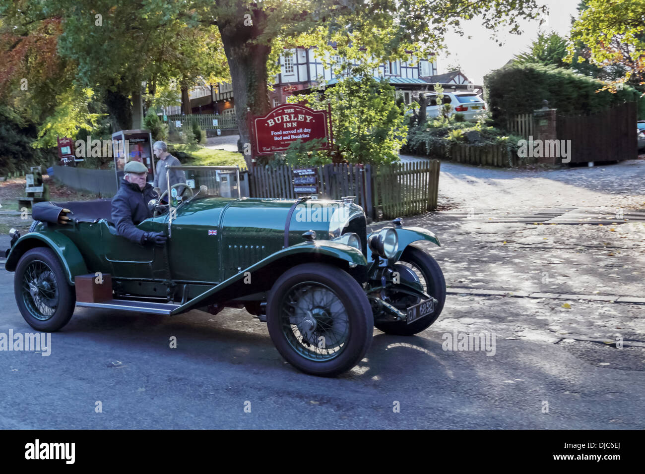 Vintage car driving through the New Forest village of Burley. Hampshire