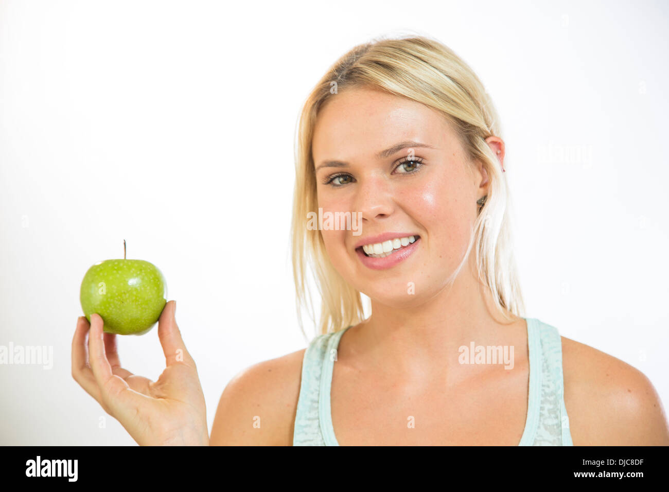 Young woman holding an apple Stock Photo