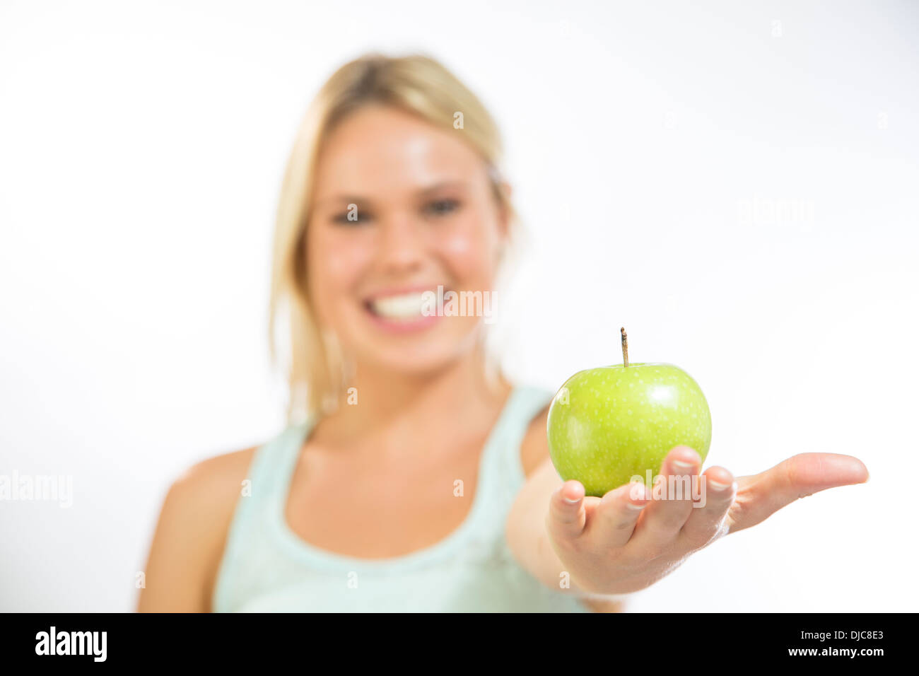 Young woman holding an apple Stock Photo