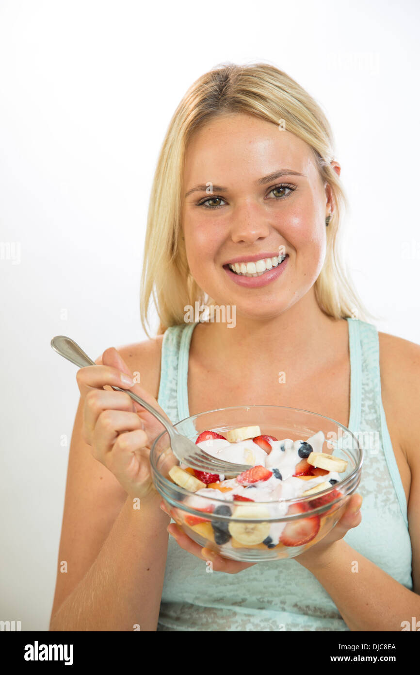 Woman eating fruit salad Stock Photo Alamy