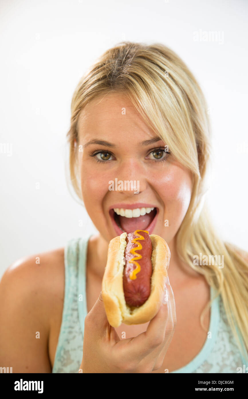 Young woman eating a hot dog Stock Photo