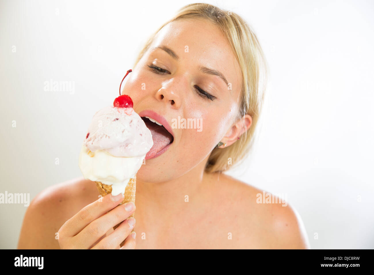 Young woman eating ice cream Stock Photo