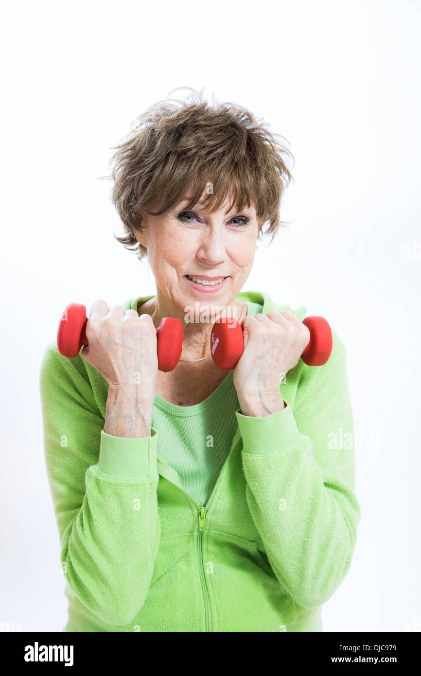 Mature woman exercising with hand weights Stock Photo