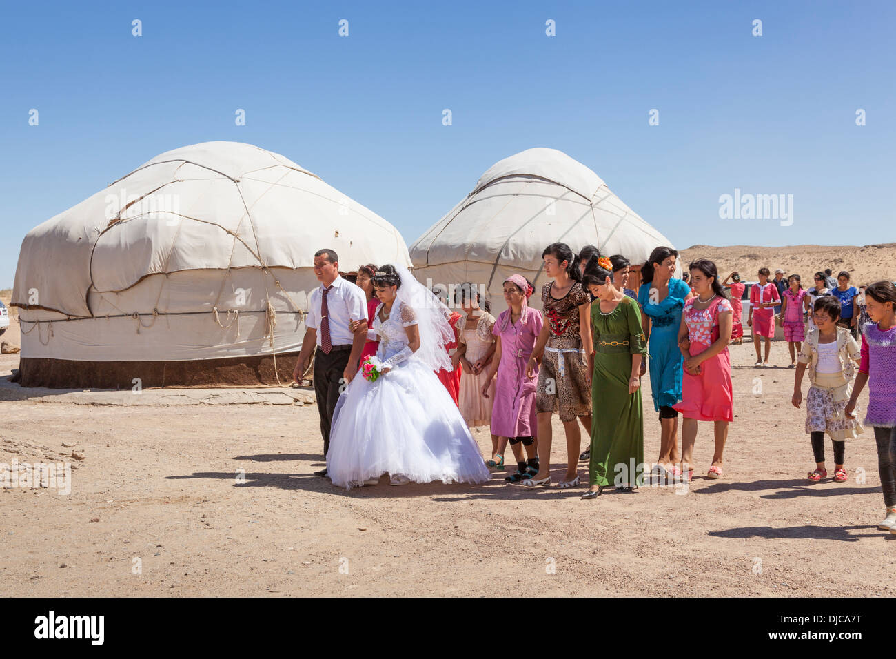 Wedding party in front of yurts, Ayaz Kala Yurt Camp, Ayaz Kala, Khorezm, Uzbekistan Stock Photo
