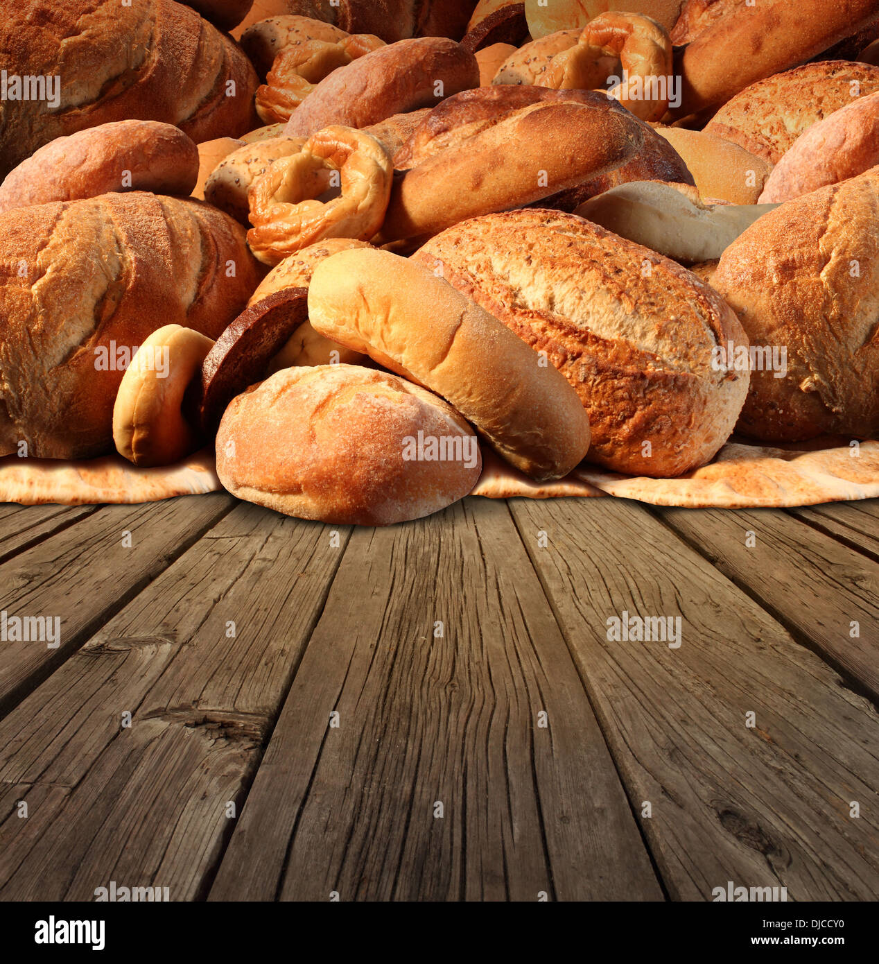 Bakery bread food concept on an old fashioned wood table background with a group of baked goods made from whole wheat and natural grains with international breads as pumpernickel pita focaccia bagel and french baguette. Stock Photo