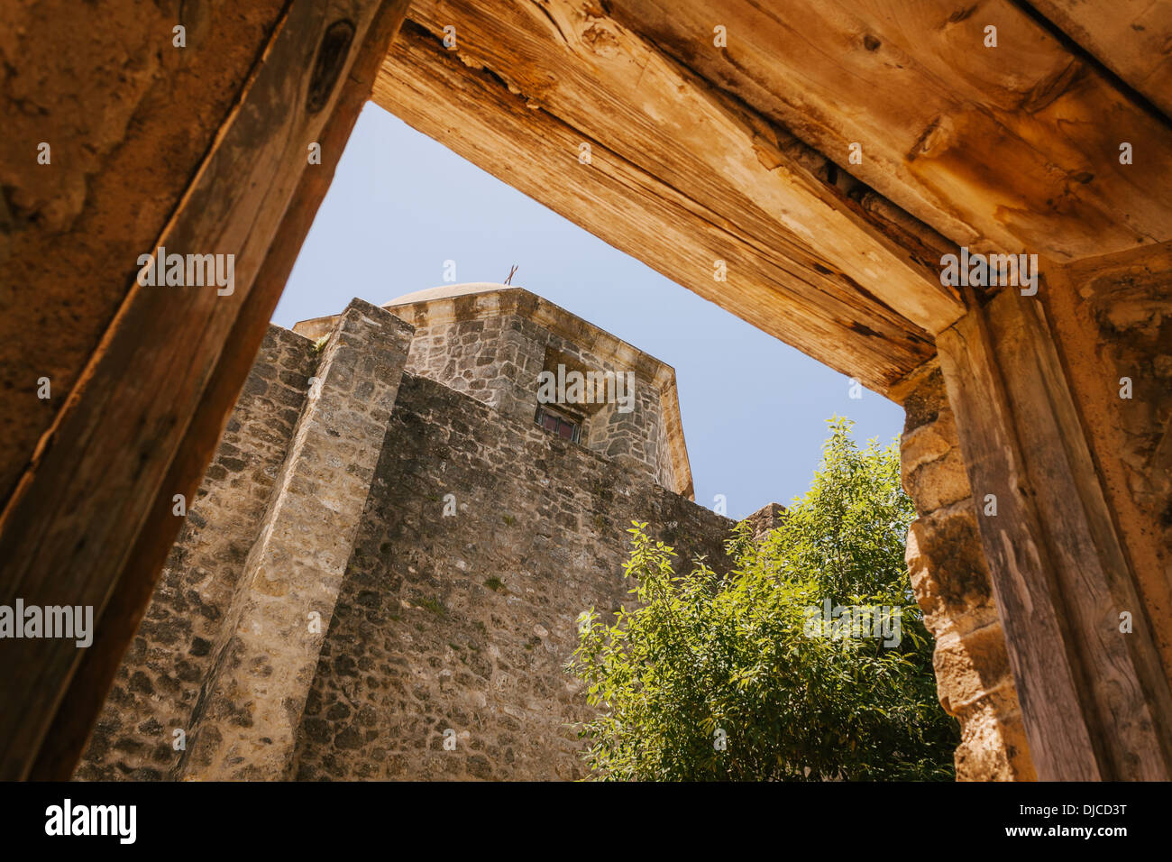 The dome of the church at Mission Concepcion is framed by a wooden portal. San Antonio, Texas