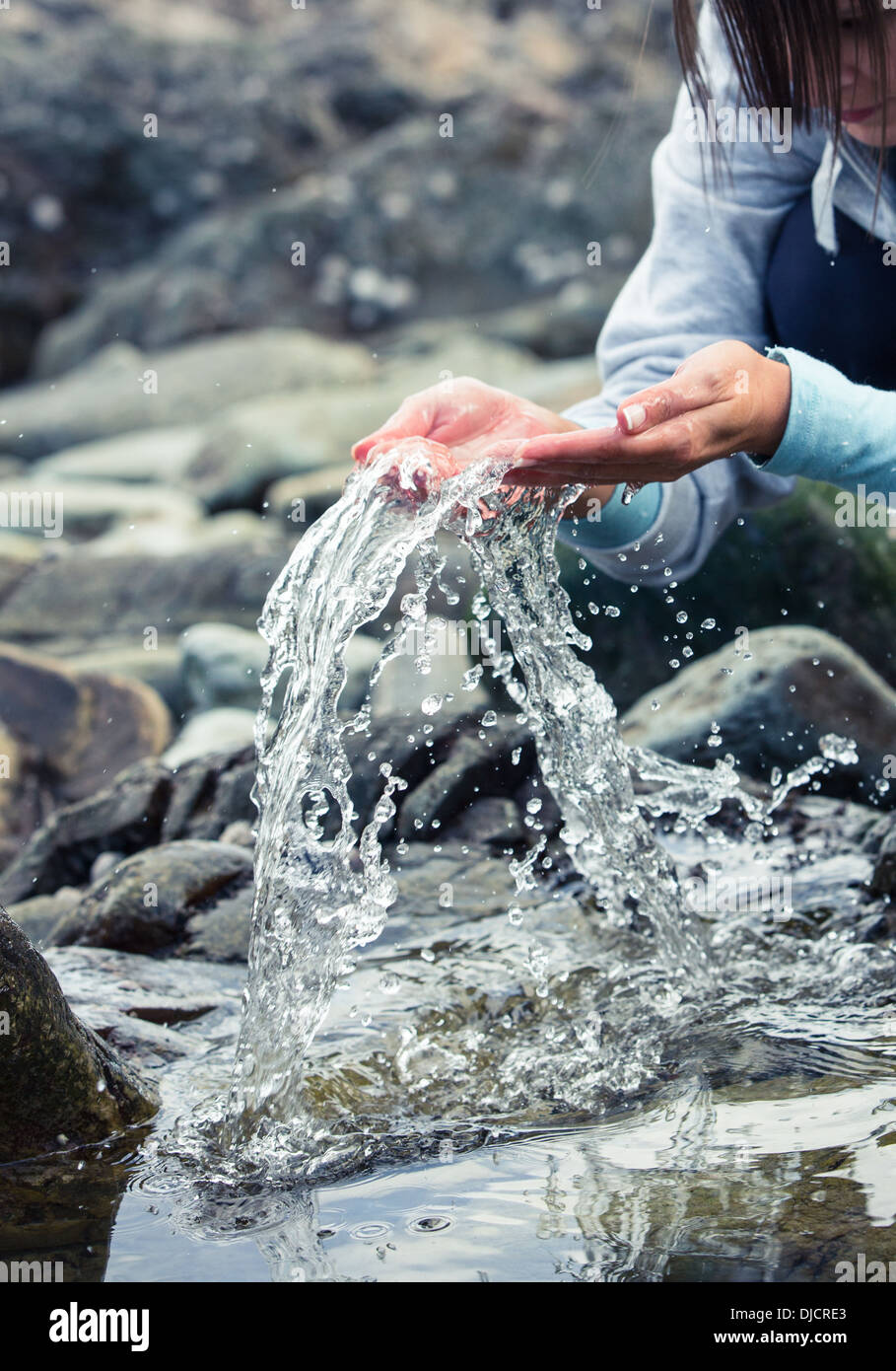 Woman splashing water of the river Stock Photo