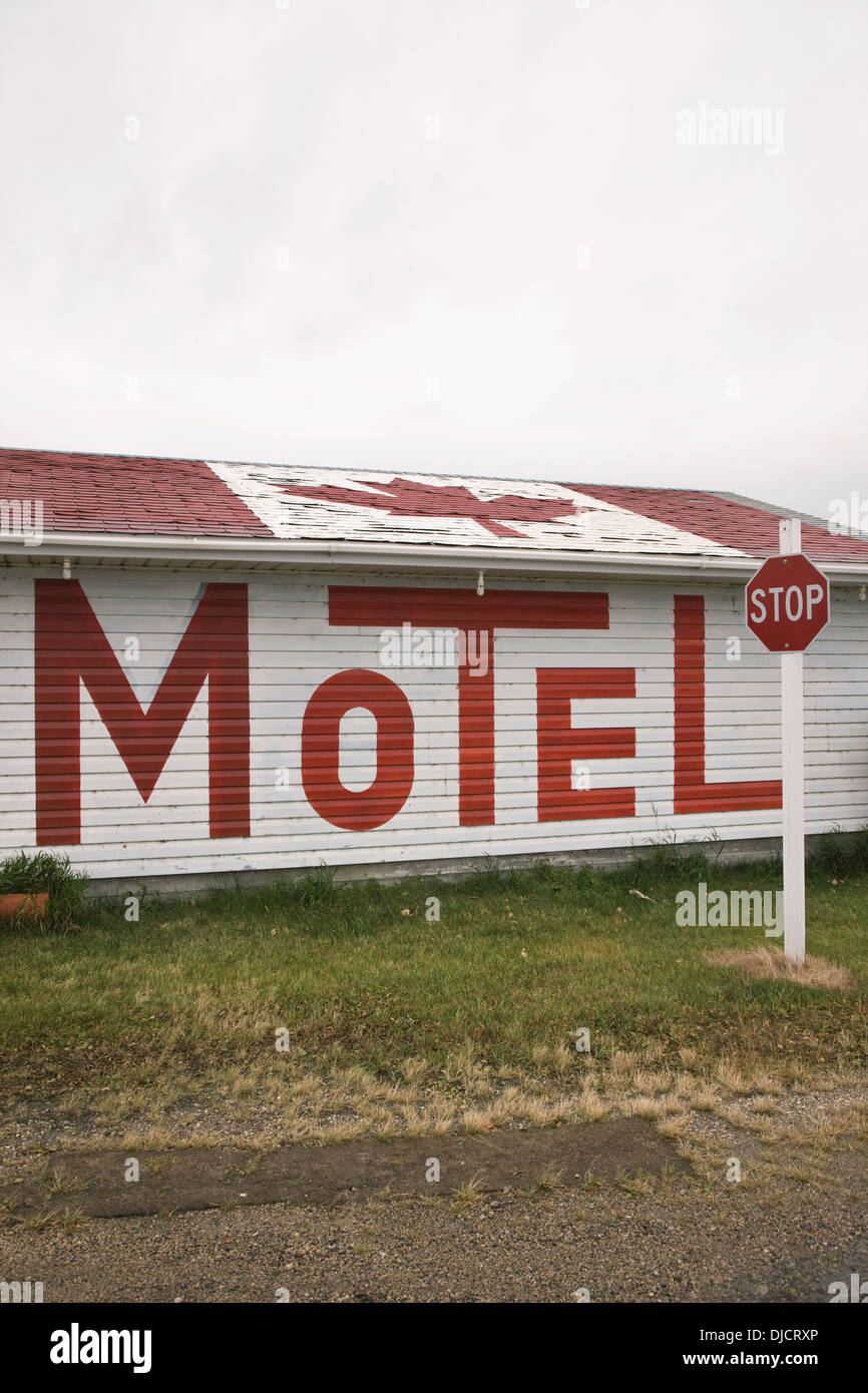 A Motel Sign Written In Large Letters On The Side Of The Building And A Canadian Flag On The Roof; Broadview, Saskatchewan Stock Photo