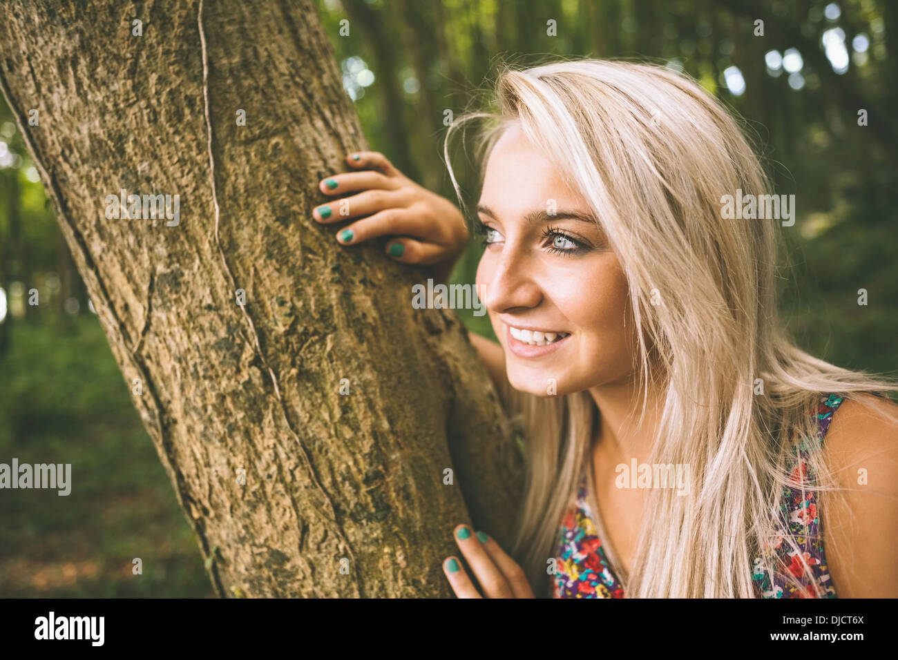 Female leaning against tree hi-res stock photography and images - Alamy