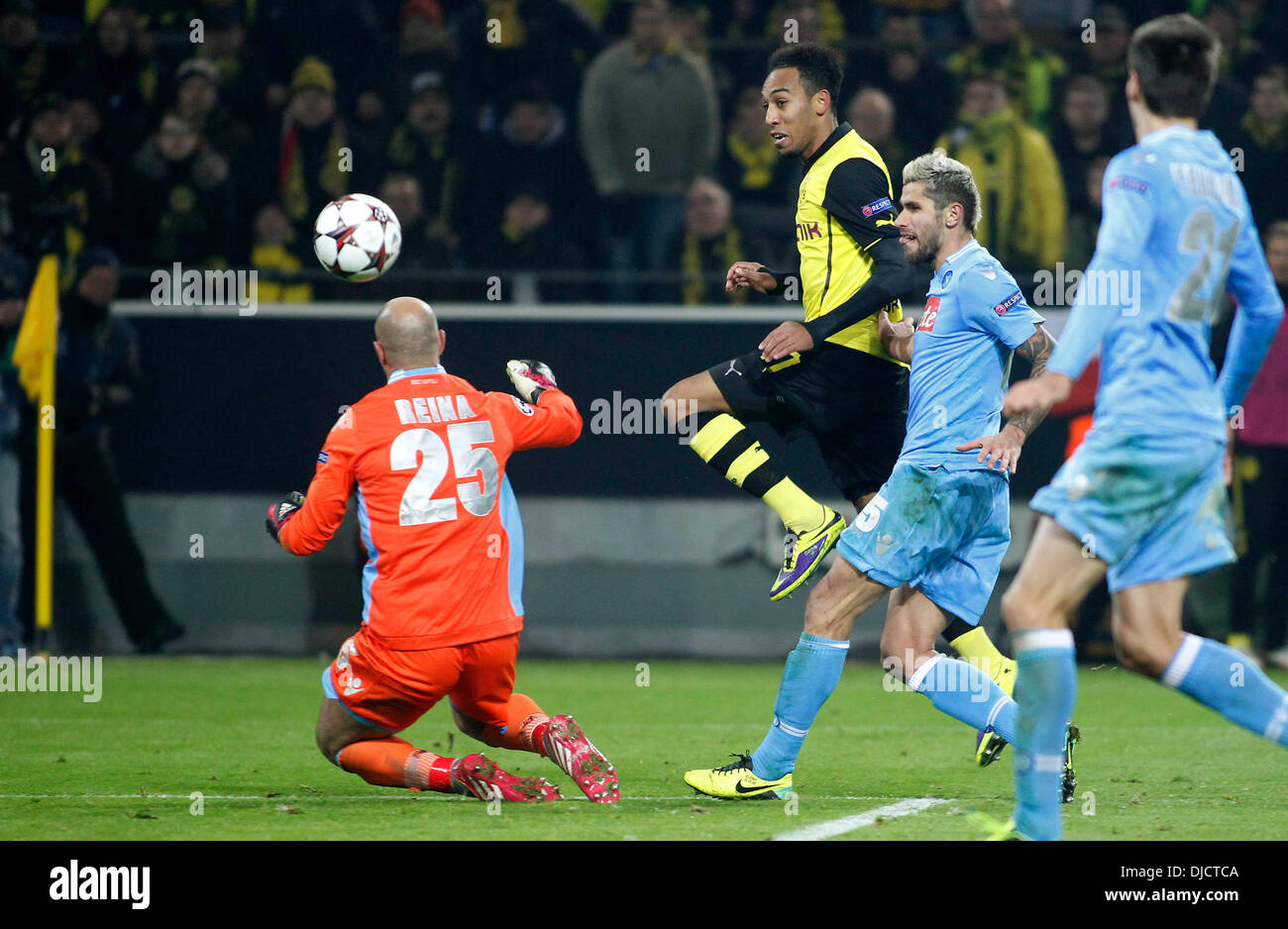 Dortmund's Pierre-Emerick Aubameyang (centre) shoots the 3-1 against  Napoli's goalkeeper PEPE REINA during the Champions League match between  Borussia Dortmund and SSC Naples, Signal Iduna Park in Dortmund on November  26, 2013