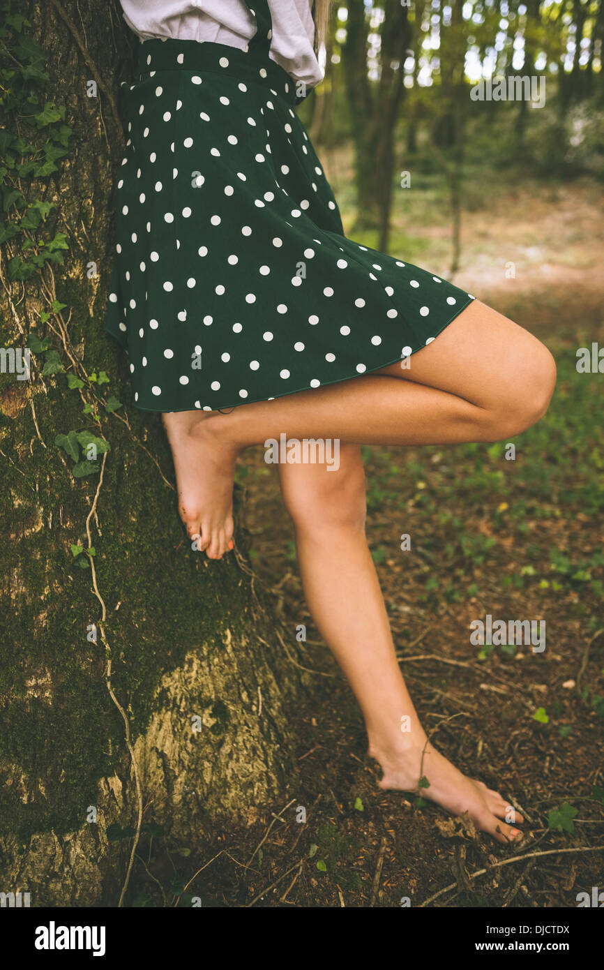 Legs of a woman wearing a polka dot skirt Stock Photo