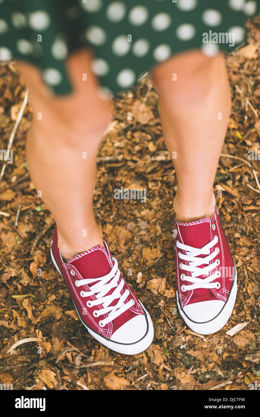 Picture of female feet wearing red trainers Stock Photo