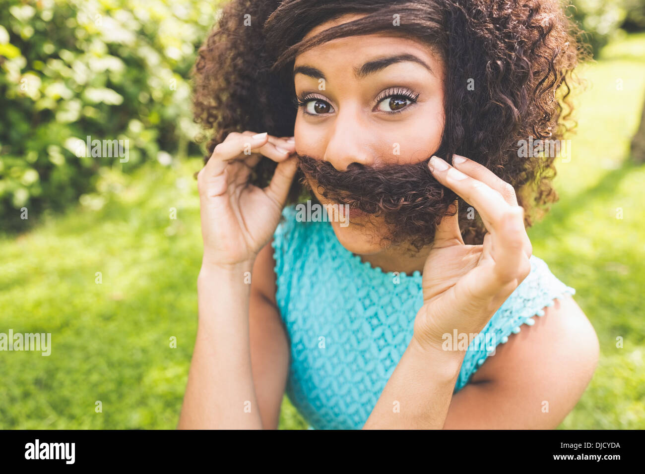 Gorgeous content brunette pretending having mustache Stock Photo