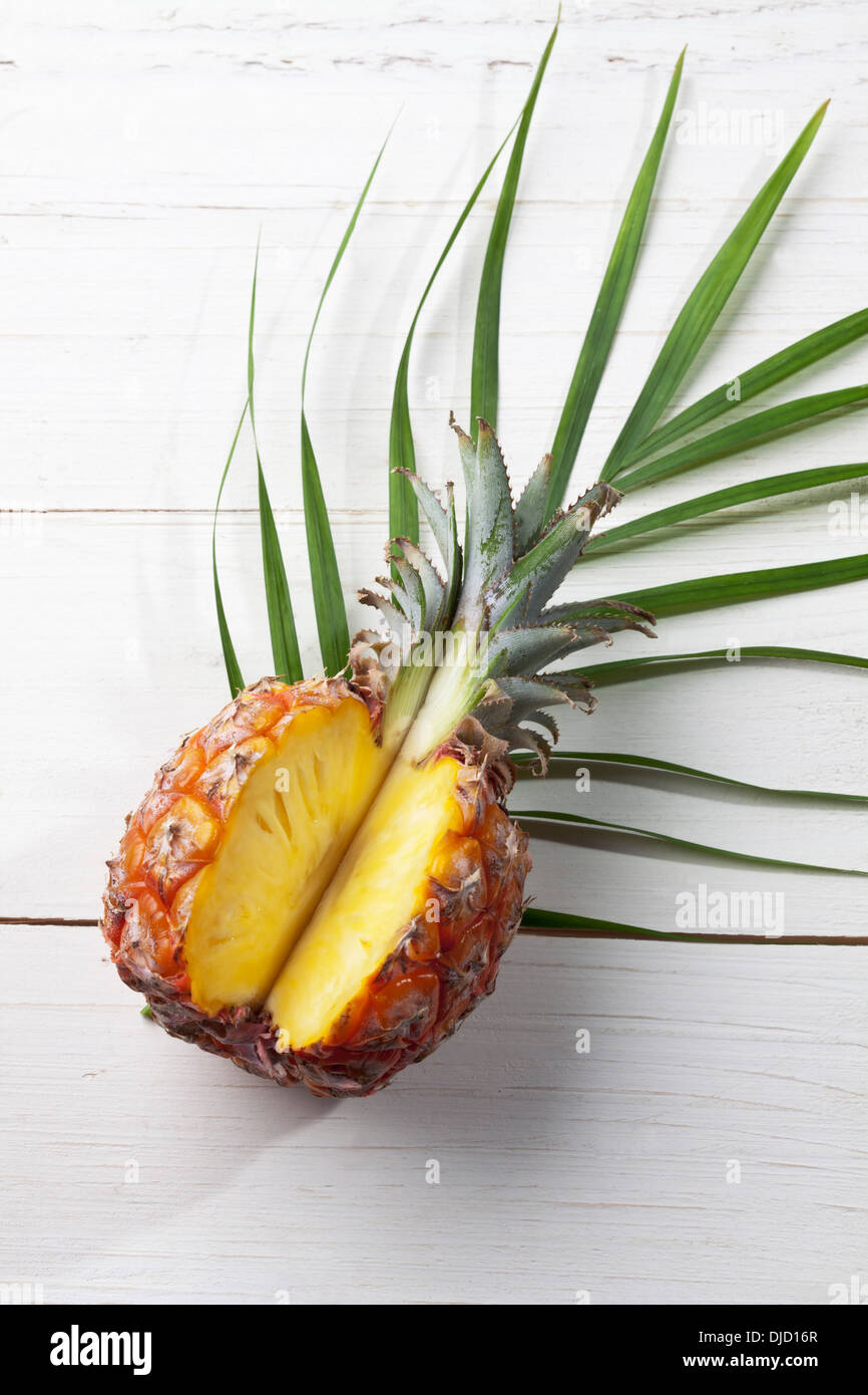 Slices pineapple on palm leaf, studio shot Stock Photo