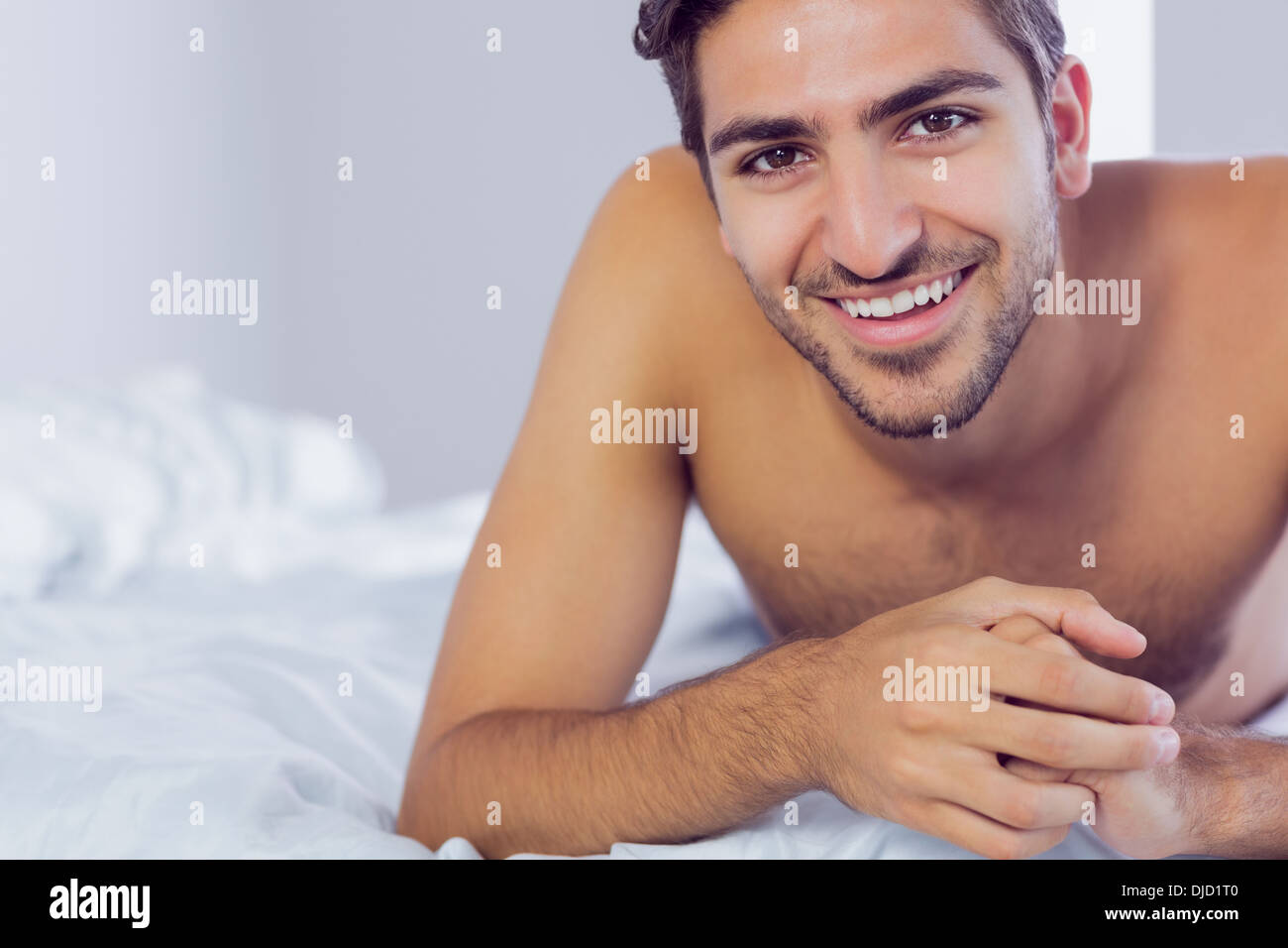 Handsome man lying on his bed Stock Photo
