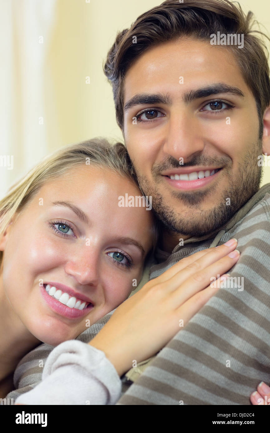 Cute couple cuddling in the living room Stock Photo