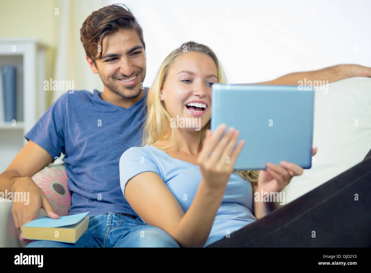 Happy laughing young couple using a tablet Stock Photo