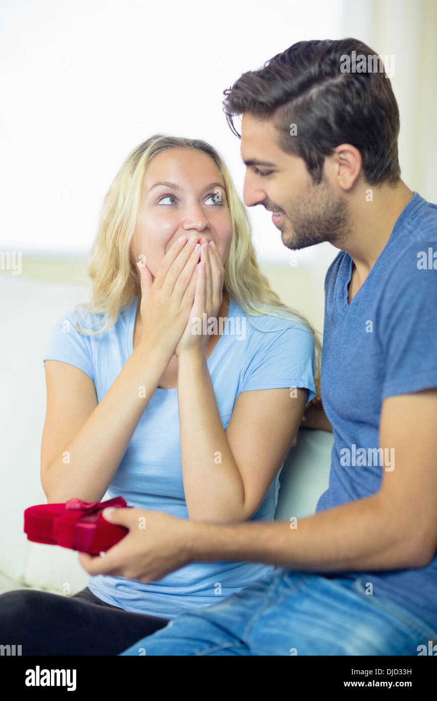 Young man offering a romantic gift to his girlfriend Stock Photo