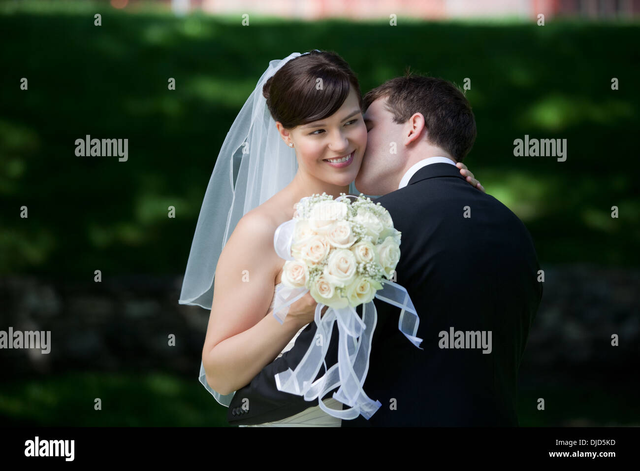 Newlywed Couple Kissing Stock Photo - Alamy