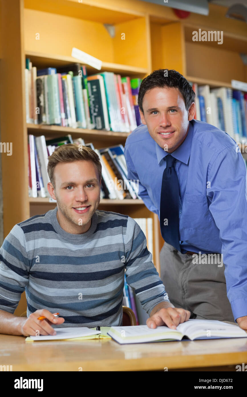 Smiling lecturer and student looking at camera Stock Photo - Alamy