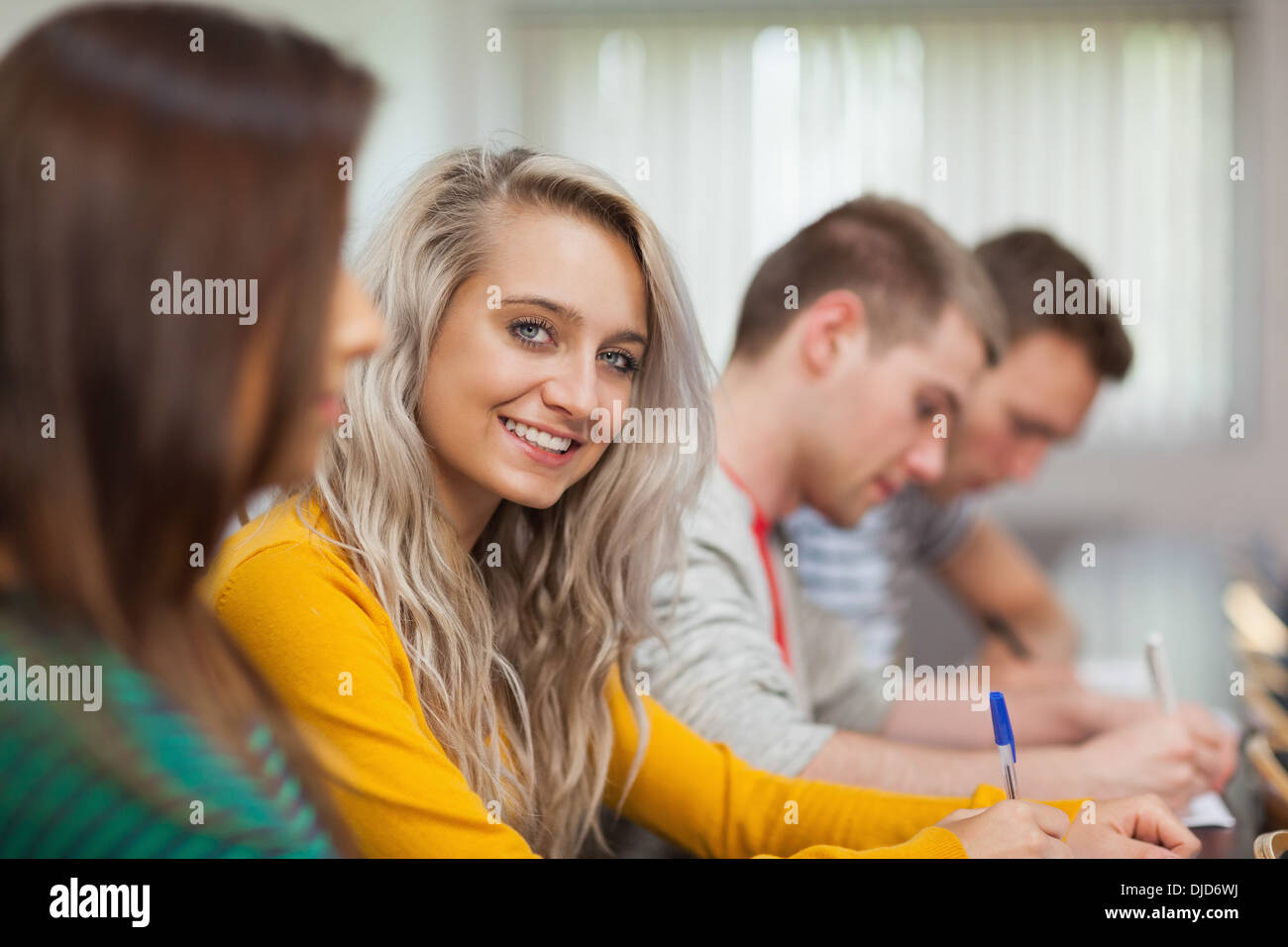 Blonde happy student looking at camera Stock Photo