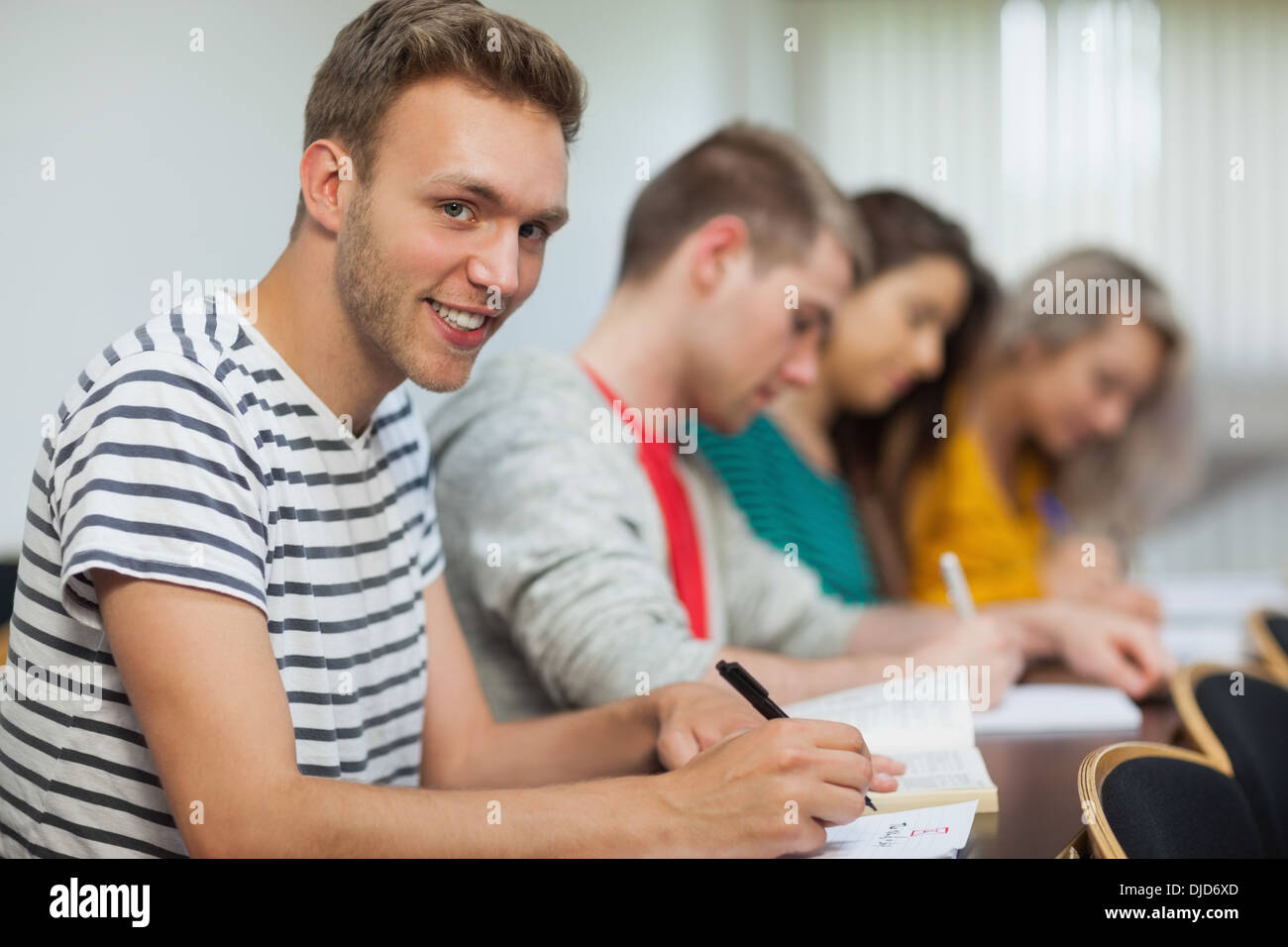 Smiling handsome student looking at camera Stock Photo