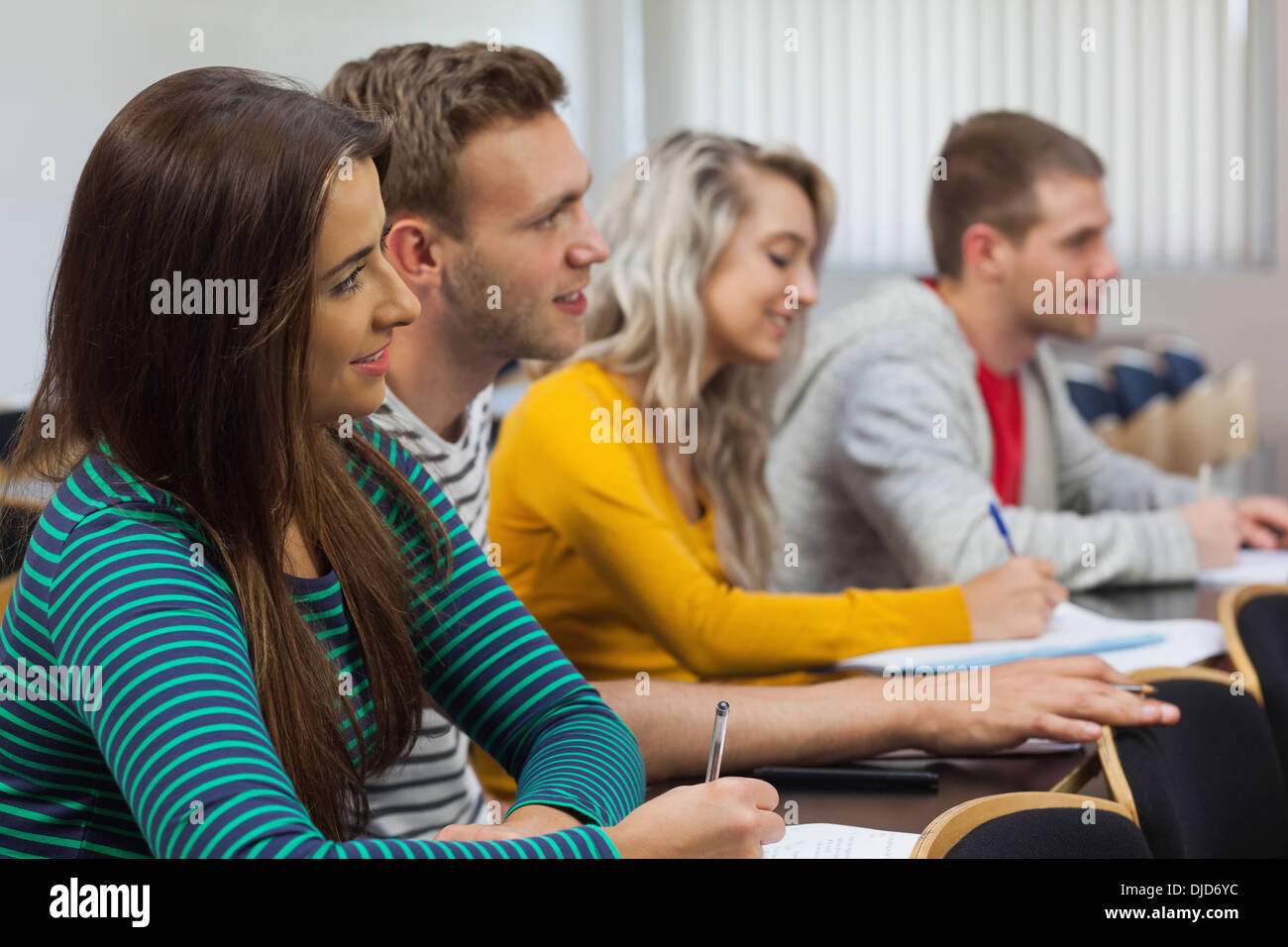 Attentive students taking notes Stock Photo