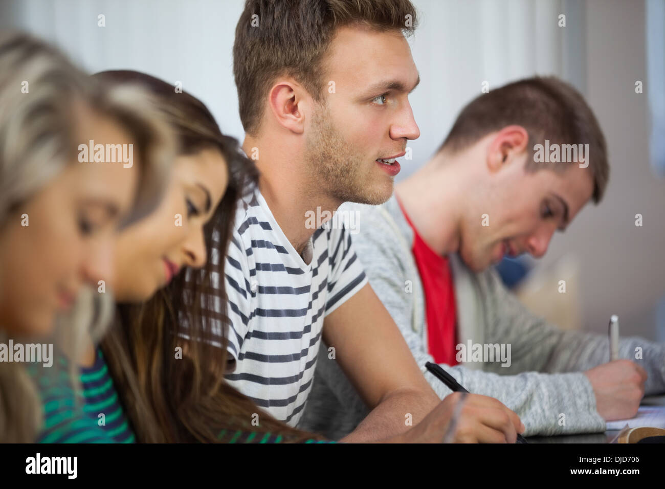 Casual attentive students taking notes Stock Photo