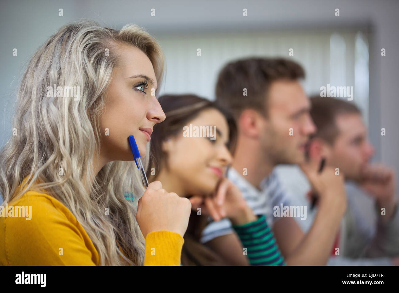 Blonde attentive student looking away Stock Photo