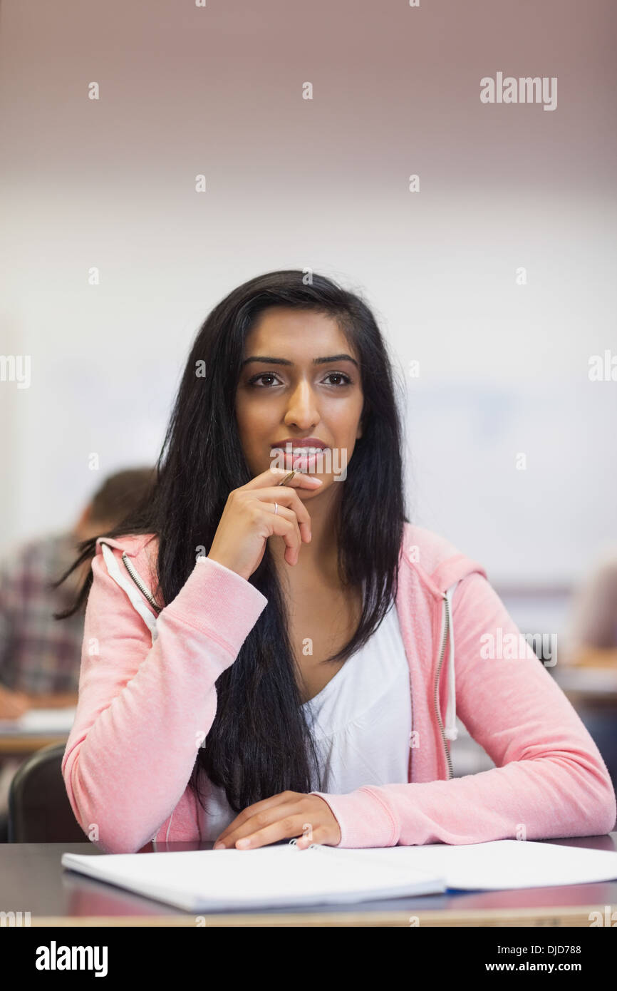 Smiling indian student listening in class Stock Photo