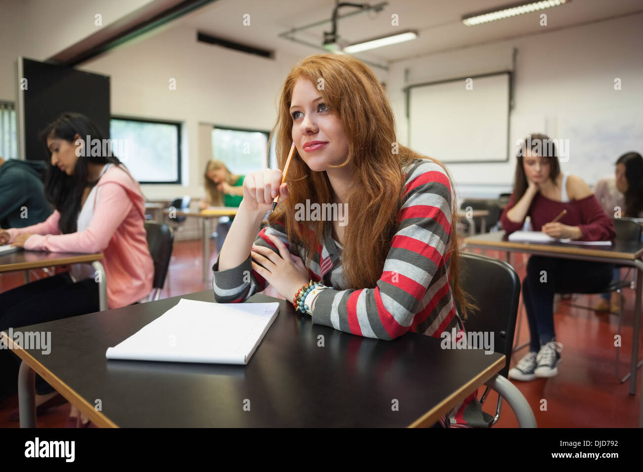 Focused female student listening in class Stock Photo