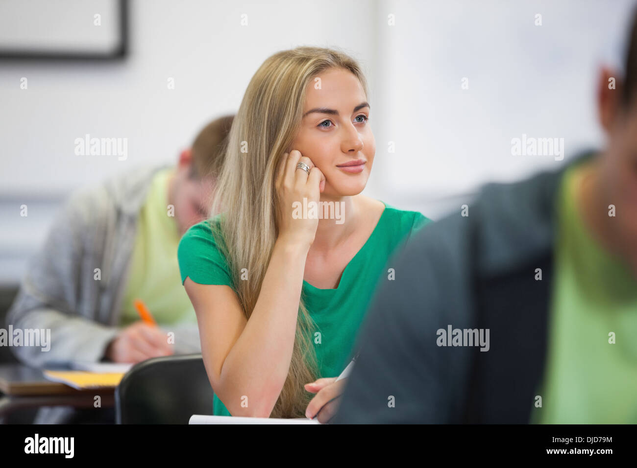 Happy blonde student listening in class Stock Photo