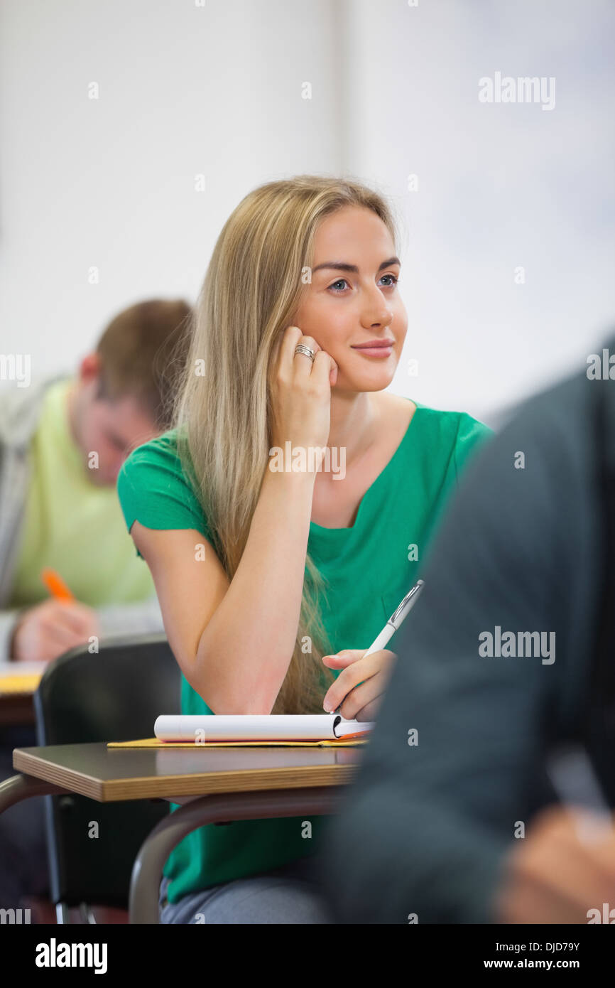 Pretty blonde student listening in class Stock Photo