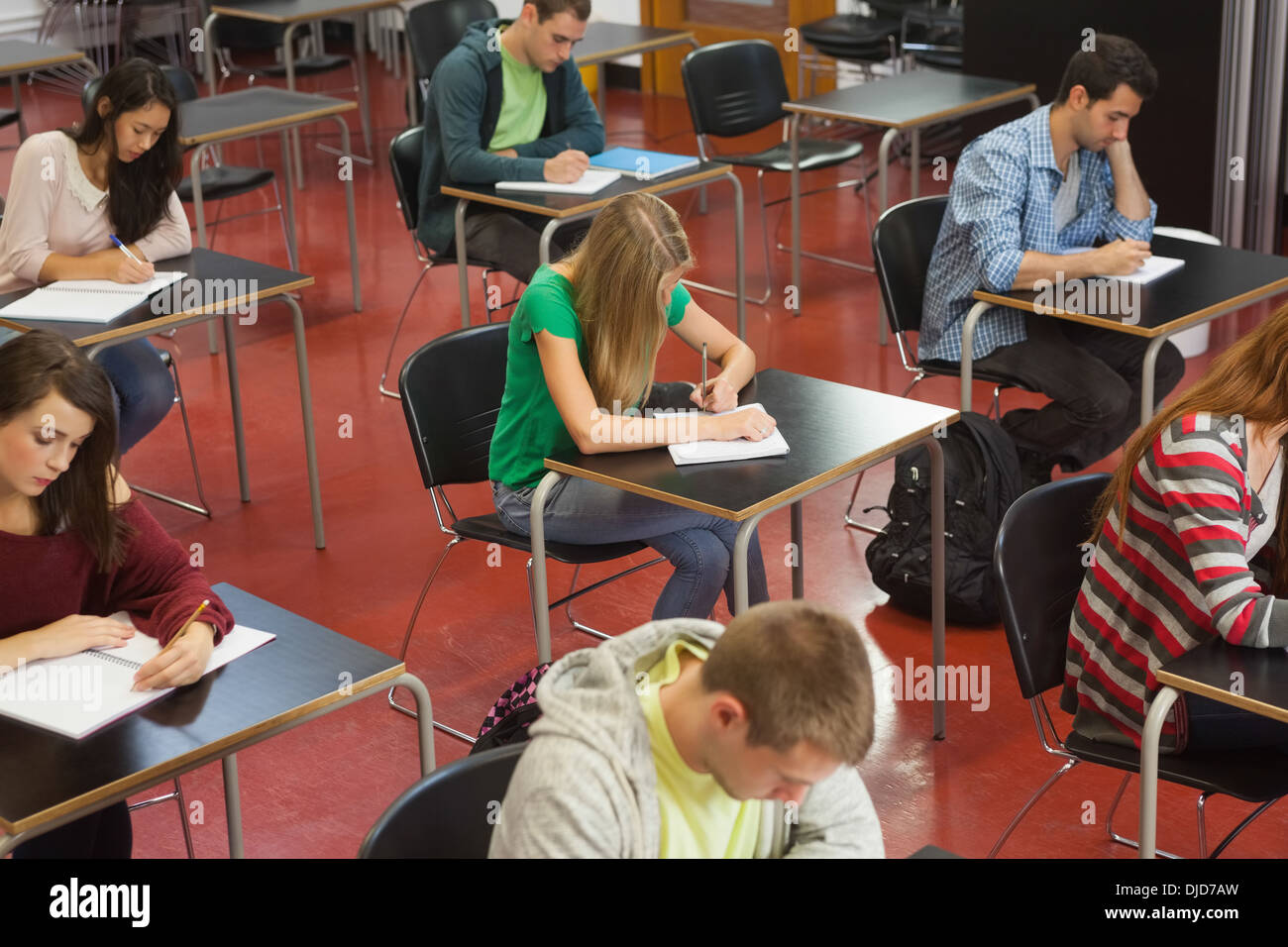 Students taking an exam in classroom Stock Photo