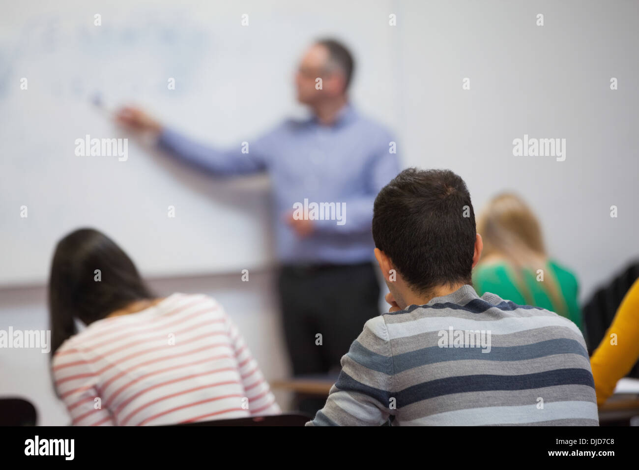 Students listening to their teacher in classroom Stock Photo